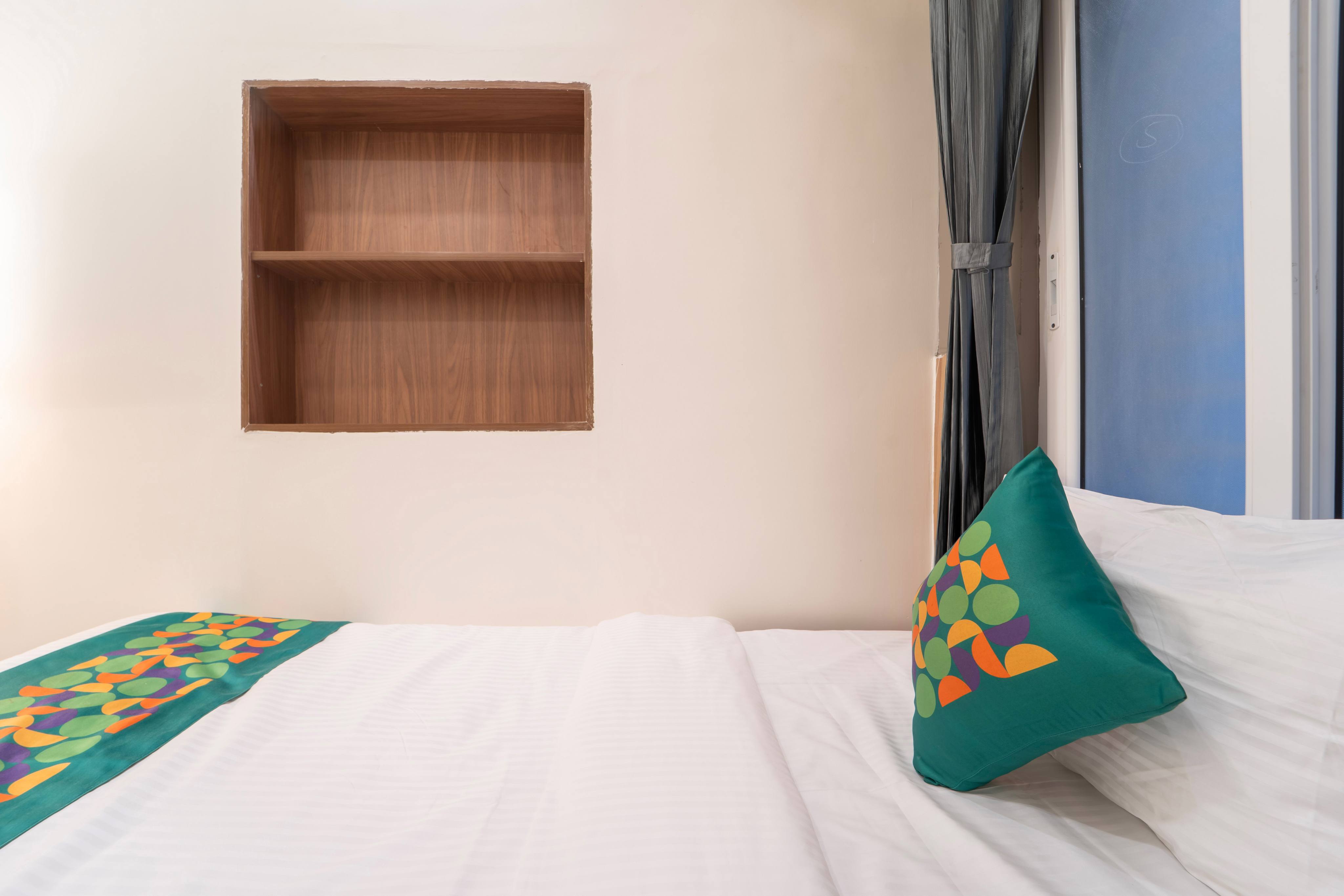 Guest room with a colorful bed and window